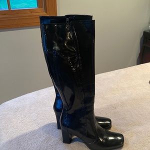 Knee high Black leather shiny boots zipper on the inside size 8, heel is 3” high